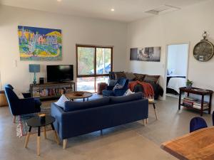 a living room with a couch and a tv at Omaroo High Country Retreat in Bonnie Doon