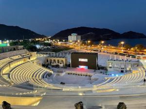 a large amphitheater at night with a city at AL MARSA HOTEL APARTMENTS in Khor Fakkan