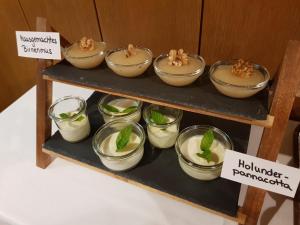 a shelf with bowls of food on a table at Pension Gartscheid in Lana