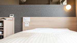 Voodi või voodid majutusasutuse Super Hotel Kanku Kumatoriekimae toas