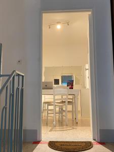 a dining room with a table and a laptop on it at B&b Kamaraton in Marina di Camerota