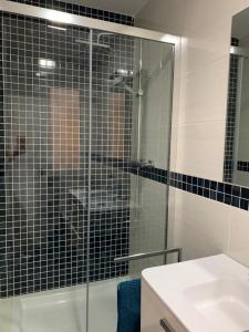 a bathroom with a glass shower and a sink at SG Apartamentos LA CASA DE LA CATEDRAL VUT47-240 in Valladolid +27 photos