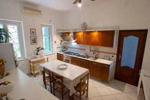 a kitchen with a table and a dining room at L'eco delle sirene in Amalfi