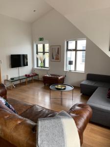 a living room with a couch and a table at Mengi Apartments in Reykjav&iacute;k