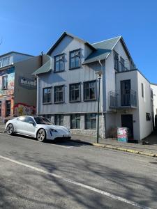 a silver car parked in front of a building at Mengi Apartments in Reykjavík