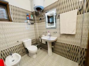 a bathroom with a toilet and a sink at Atlantis Apartments in Orikum +14 photos