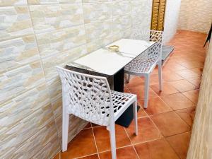 a white table and chairs in a room at Atlantis Apartments in Orikum