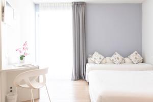 Postel nebo postele na pokoji v ubytování Aromi Piccolo Hotel
