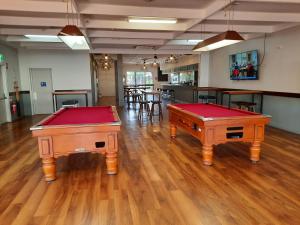 two pool tables sitting on a hard wood floor at Boab Inn in Derby
