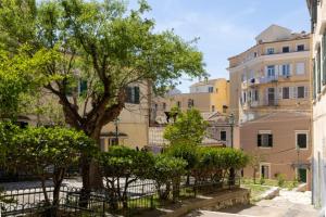 una via cittadina con edifici e un albero di Little Bright Studio · Corfu Old Town a Città di Corfù