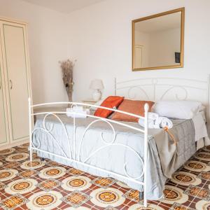 a white bed in a room with a mirror at Albergo Diffuso Bacco Furore in Furore