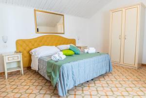 a bedroom with a bed and a dresser at Albergo Diffuso Bacco Furore in Furore