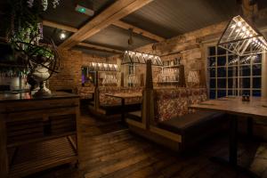 a bar with benches and tables in a room at Crux in Alnwick