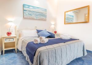 a bedroom with a bed with towels on it at Albergo Diffuso Bacco Furore in Furore