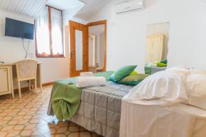 a bedroom with a bed with towels on it at Albergo Diffuso Bacco Furore in Furore