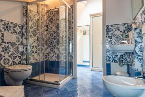 a bathroom with a shower and a toilet and a sink at Albergo Diffuso Bacco Furore in Furore