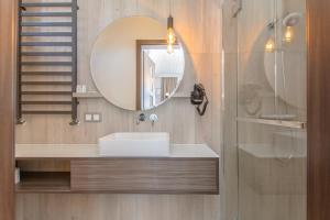 a bathroom with a sink and a mirror at Pokoje Gościnne Krzyś in Karwia