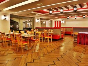 a dining room with tables and chairs in a restaurant at JOHNY INTERNATIONAL HOTEL in Muscat