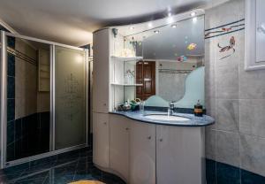 a bathroom with a sink and a shower at Melisses Sea View House in Plaka Milou +26 photos