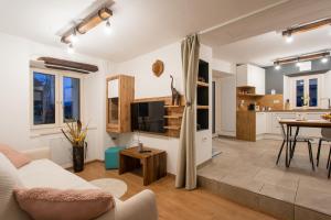 ein Wohnzimmer mit einem Sofa und einem Tisch in der Unterkunft Apartma Ob stari murvi, Sežana in Sežana
