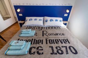 a bedroom with a bed with a blue wall at Standard B&B in Civitanova Marche