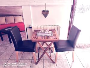 a table and two chairs in a room at Albert Apartaments Krk in Krk +9 photos