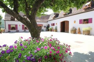 un árbol y flores frente a un edificio en Hotel Le Manasses en Curtil-Vergy