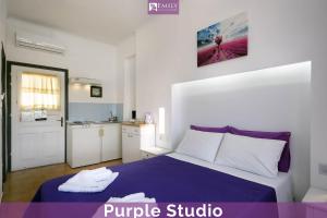 a bedroom with a purple bed and a kitchen at Emily Apartments Dassia in Dassia