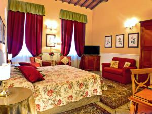 a bedroom with a bed and a couch and red curtains at Hotel Rosary Garden in Florence