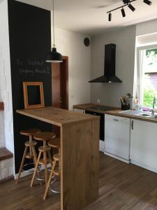 a kitchen with a counter and stools in it at Kopalnia Wspomnień in Kopalino
