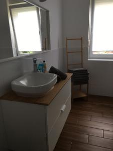 a bathroom with a white sink and a mirror at Kopalnia Wspomnień in Kopalino +19 photos