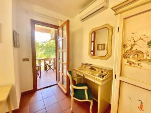 a bathroom with a sink and a mirror at Hotel Grazia Deledda in Arzachena