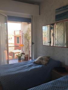a bedroom with a bed and a view of a balcony at IN CENTRO A RAPALLO in Rapallo