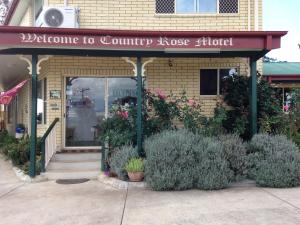 a building with a sign on the front of it at Country Rose Motel Warwick in Warwick