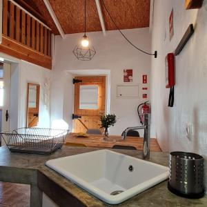 a kitchen with a large white sink on a counter at Casa Blanca in Odeceixe