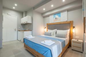 a bedroom with a bed with two towels on it at Armonia Rooms in Myrina