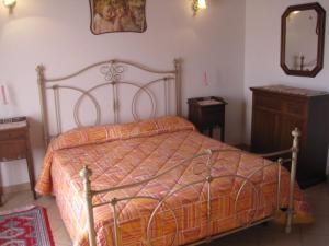 a bedroom with a bed and a mirror and a dresser at Agriturismo Alla Strozza in Voghenza