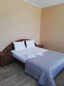 Postel nebo postele na pokoji v ubytování Prometey Hotel