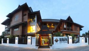uma casa grande com uma loja em frente em Burapa Boutique em Chiang Mai