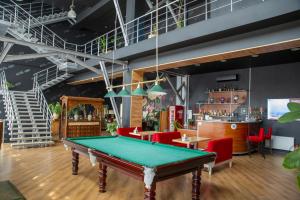 a pool table in a room with red chairs at Hotel Nika 2 in Chornomorsk