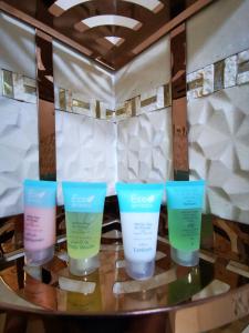 four bottles of sunscreen sitting on a table at ALBERI LODGE in Hatta