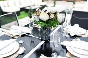 a vase of flowers sitting on a table with glasses at Luxury Cottage - City Center - Large Garden with Hot Tub -7 Bedrooms-4 Bathrooms in Galway