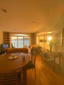 a living room with a table and a couch at No.21 Sandpiper's Nest Apartment in Valentia Island