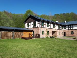 a large brick building with a yard in front of it at Siedlisko Role in Role