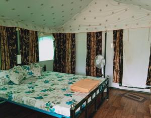 a bedroom with a bed in a tent at Jungle retreat dandeli - Homestay in Joida