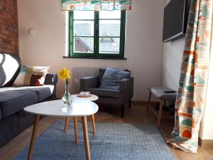 a living room with a couch and a table at Siedlisko Role in Role