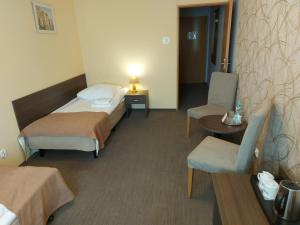 Postel nebo postele na pokoji v ubytování Hotel IKAR