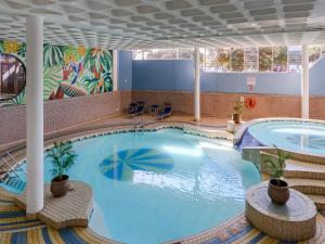 a large swimming pool in a hotel room with a large pool at Durban Spa in Durban