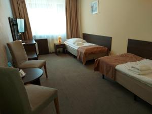 Postel nebo postele na pokoji v ubytování Hotel IKAR