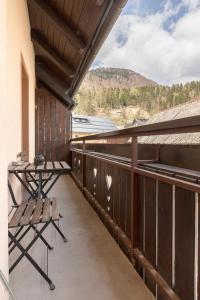 a balcony with a bench and a table on it at Hostel Mama Minka in Bohinj